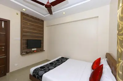 a bedroom with a bed and a flat screen tv at Sri Kamadhenu Residency in Coimbatore
