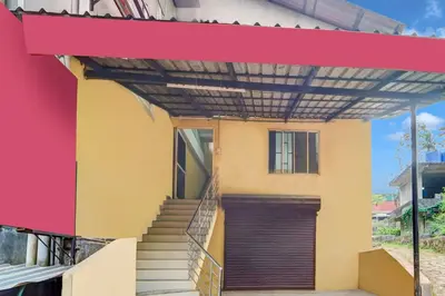 a building with awning and stairs in front of it at Super Hotel O Kunnamangalam Near Bus Stand in Calicut