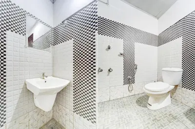 a bathroom with a toilet and a sink at Super Hotel O Kunnamangalam Near Bus Stand in Calicut