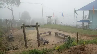 two benches in a field in the fog at Aden Valley in Kanthalloor