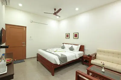 a bedroom with a bed and a couch at Green Planet Resort in Mattanūr