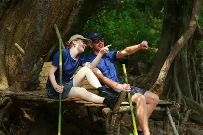 a man and a woman sitting on a raft at Hotel VKJ International Kuttampuzha in Thattakād