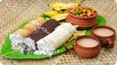 a green plate with a piece of cake and some food at Hotel VKJ International Kuttampuzha in Thattakād