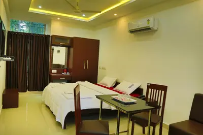 a hotel room with a bed and a table and a tableablish at karibu Residency in Malappuram