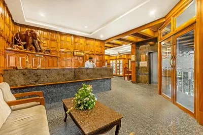 a lobby of a hotel with a counter and a table at Sterling Darshan Guruvayur in Guruvāyūr