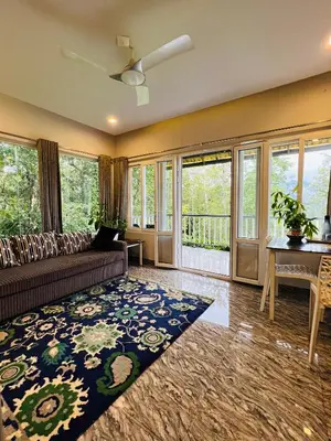 a living room with a couch and a table at Villa Tesori Homestay Wayanad in Meppādi