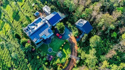 an overhead view of a large house in the forest at Villa Tesori Homestay Wayanad in Meppādi