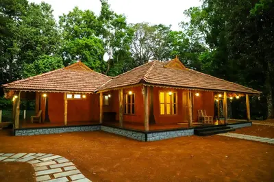 a small wooden house with lights on it at 900 Woods Wayanad Eco Resort - A Sprawling Jungle Stay near Glass Bridge in Meppādi