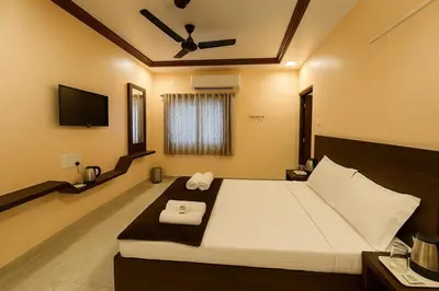 a bedroom with a bed with two towels on it at Sakthimurugan residency in Erode