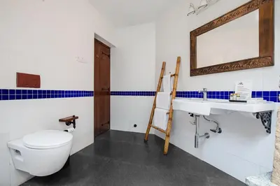 a bathroom with a toilet and a sink at My Village - Eco Rural Resort in Coimbatore