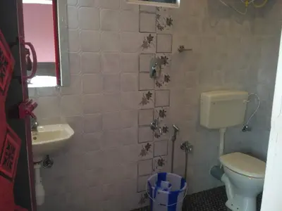 a bathroom with a toilet and a sink at The Meadows in Kodaikānāl
