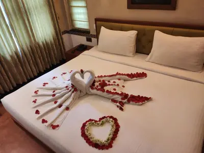a bed with a heart made out of red pedals at Chembra Adobe in Kalpetta