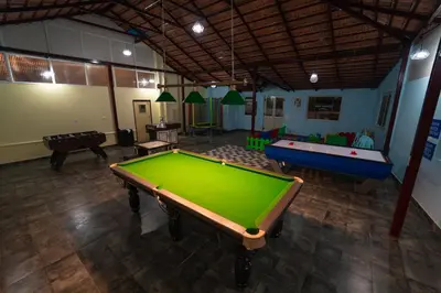 a large room with a pool table and several tables at KINGMAKER'S Plantation with River Stream in Madikeri
