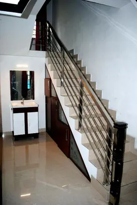 a staircase in a house with a sink and a bathroom at NICE VILLA in Irimbranallūr
