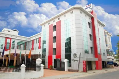 a red and white building on a city street at KPM Regency in Palakkad
