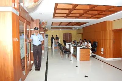 a man walking down a hallway in a restaurant at KPM Regency in Palakkad