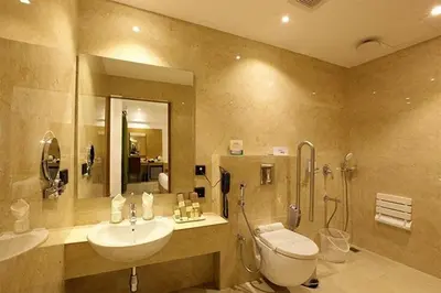 a bathroom with a sink and a toilet and a shower at Park Residency Kodungallur in Trichūr
