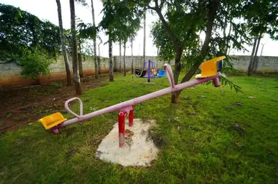 a playground in a park with a play equipment at vihangama Home Stay in Chāmundi