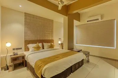 a bedroom with a large bed and a window at AS AIRPORT Inn in Cochin