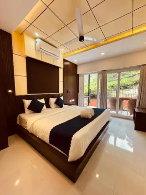 a bedroom with a large bed in a room at IRON BRIDGE COVE in Meppādi