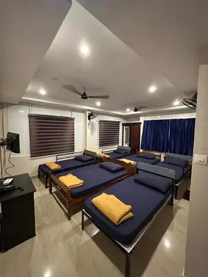 a room with a bunch of beds in it at Fresh Up In Guruvayur Krishnendhu Residency in Guruvāyūr