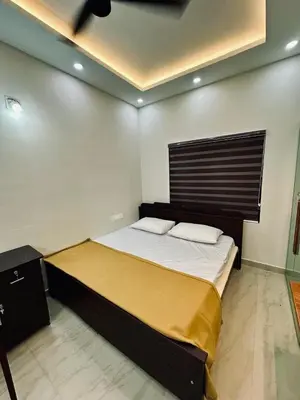 a bedroom with a large bed with a wooden headboard at Fresh Up In Guruvayur Krishnendhu Residency in Guruvāyūr