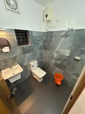 a bathroom with a toilet and a sink at Fresh Up In Guruvayur Krishnendhu Residency in Guruvāyūr