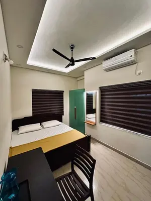 a bedroom with a bed and a ceiling fan at Fresh Up In Guruvayur Krishnendhu Residency in Guruvāyūr