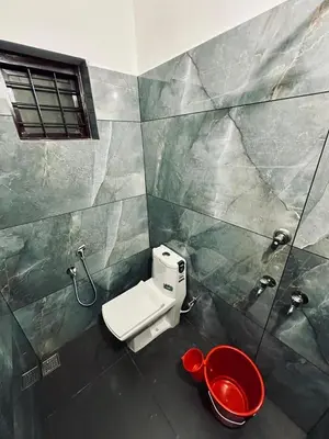 a bathroom with a toilet and a sink and a shower at Fresh Up In Guruvayur Krishnendhu Residency in Guruvāyūr