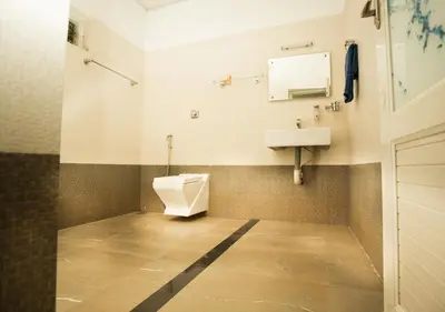a bathroom with a toilet and a sink at Vythiri Silver Mist Hilltop Villa By VOYE HOMES in Vythiri