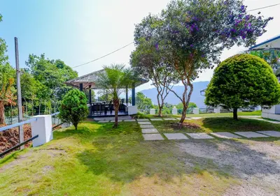 an image of a yard with a gazebo at Vythiri Silver Mist Hilltop Villa By VOYE HOMES in Vythiri