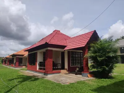 a small house with a red roof at Dubare Inn Coorg in Madikeri