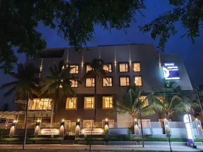 a building with lights in front of it at night at Emerald Clarks Inn Suites in Mysore