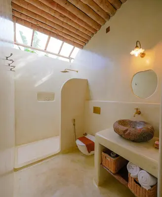 a bathroom with a sink and a toilet in a room at The Mudhouse Marayoor in Munnar