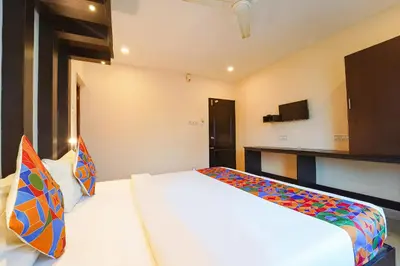 a hotel room with a bed and a tv at Zion Plaza in Nedumbassery