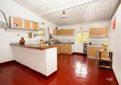 a large kitchen with a large counter in a room at Moonlight Munnar Forest Bungalow with Private Waterfalls by VOYE HOMES in Kanthalloor
