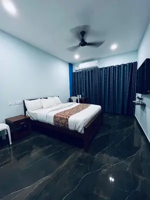 a bedroom with a bed and a ceiling at MADAPARAMBIL RESIDENCY in Alwaye