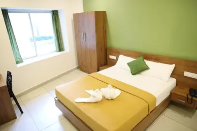 a bedroom with a bed with shoes on it at Hillfort Inn in Sultan Bathery