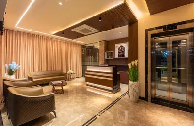 a living room with a piano and a couch at Hotel M Pro Palace Mysore - 12 Minutes to Mysore Palace in Mysore