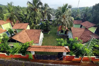 an aerial view of a group of houses with palm trees at NARMADA HOMESTAY Ganga in Perintalmanna