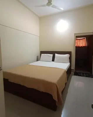 a bedroom with a large bed in a room at KABINI FARM STAY in Antarasante