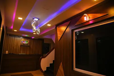 a room with a staircase with purple lights at Sivamurugan residency in Bhavāni