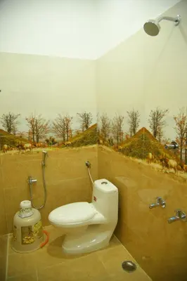 a bathroom with a toilet and a shower at Sivamurugan residency in Bhavāni