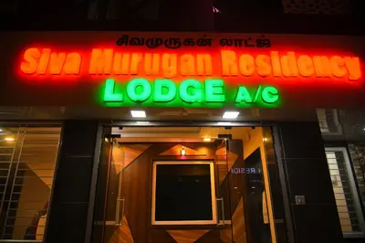 a neon sign on the front of a building at Sivamurugan residency in Bhavāni