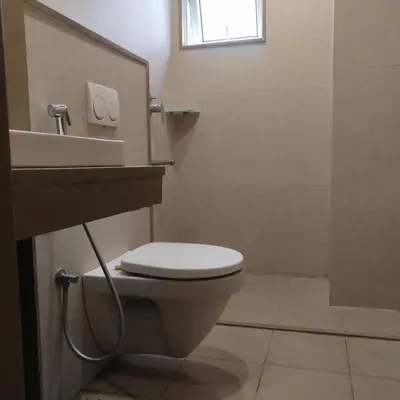 a bathroom with a toilet and a sink at PPH Living Railotel Coimbatore in Coimbatore