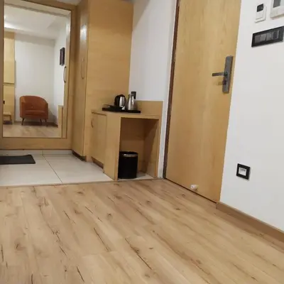 an empty room with a wooden floor and a door at PPH Living Railotel Coimbatore in Coimbatore