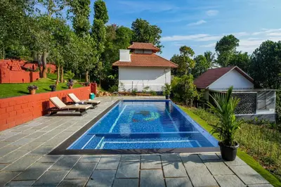 a swimming pool in the backyard of a house at Serene Valley Resort Wayanad in Mananthavady