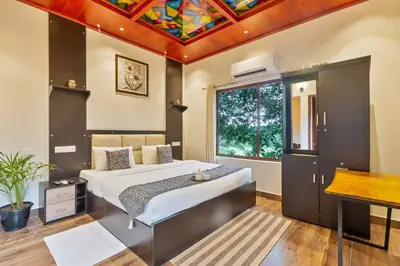 a bedroom with a bed and a colorful ceiling at Serene Valley Resort Wayanad in Mananthavady