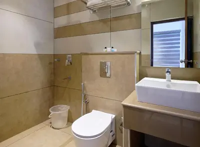 a bathroom with a toilet and a sink at Tea Garden Riverside in Munnar