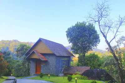 a small house in the middle of a garden at The Wild Trails Clarks Exotica , Munnar in Munnar